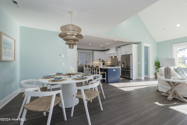 dining space with high vaulted ceiling, a chandelier, and dark hardwood / wood-style floors