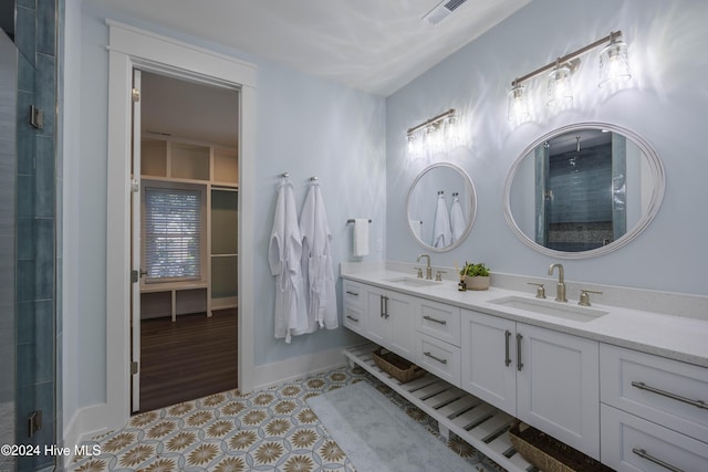 bathroom featuring vanity and a shower with shower door