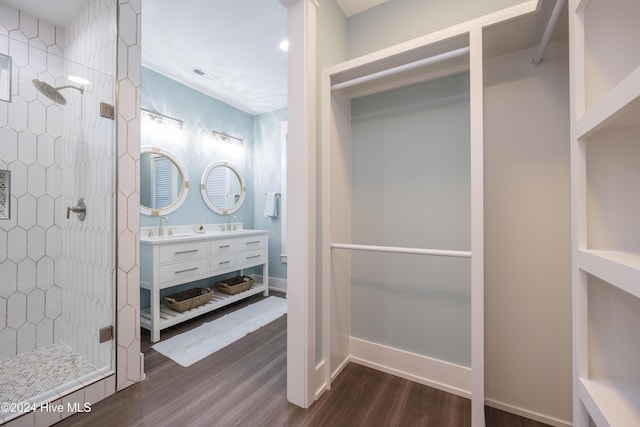 bathroom featuring vanity, a shower with door, and wood-type flooring