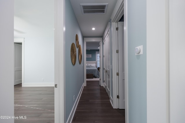 hallway with dark hardwood / wood-style flooring