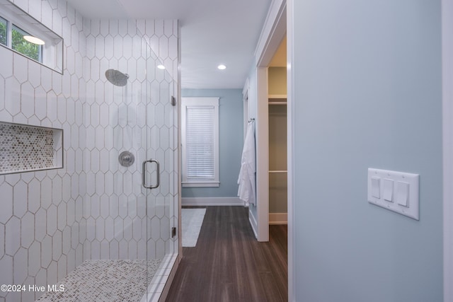 bathroom with walk in shower and wood-type flooring