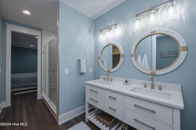 bathroom featuring vanity, a shower with door, and wood-type flooring