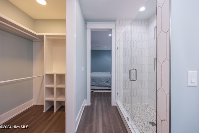 bathroom featuring hardwood / wood-style flooring and walk in shower