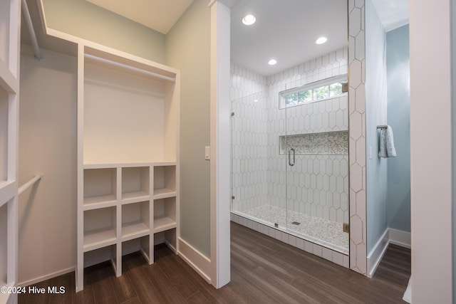 bathroom featuring hardwood / wood-style flooring and a shower with door