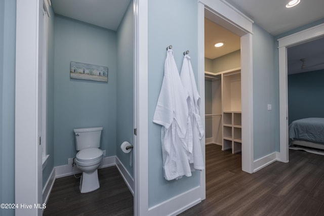 bathroom with hardwood / wood-style flooring and toilet