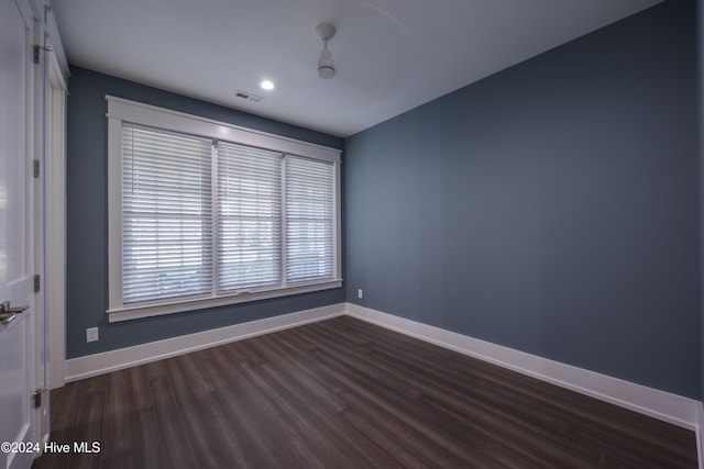 unfurnished room featuring dark wood-type flooring