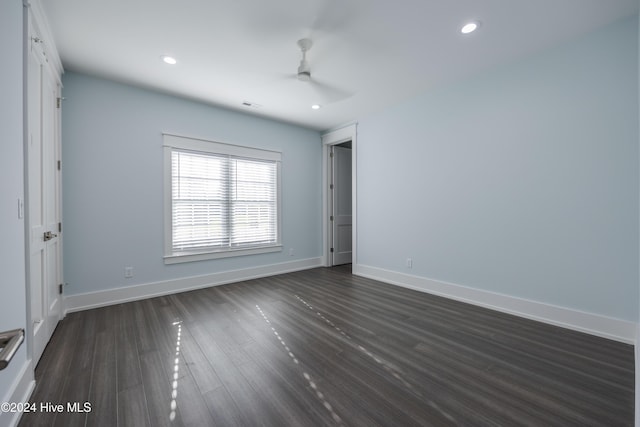 unfurnished bedroom featuring dark wood-type flooring and ceiling fan