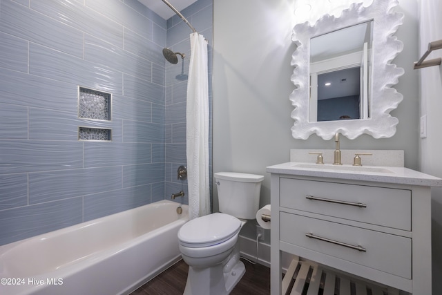 full bathroom featuring toilet, shower / bath combo, wood-type flooring, and vanity