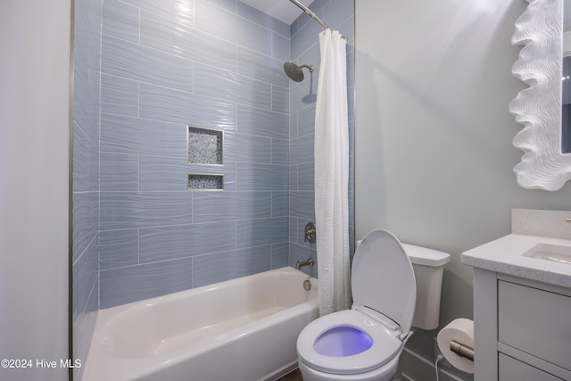 full bathroom featuring vanity, toilet, and shower / bath combo with shower curtain