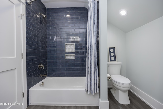 bathroom with hardwood / wood-style flooring, toilet, and shower / bath combination with curtain