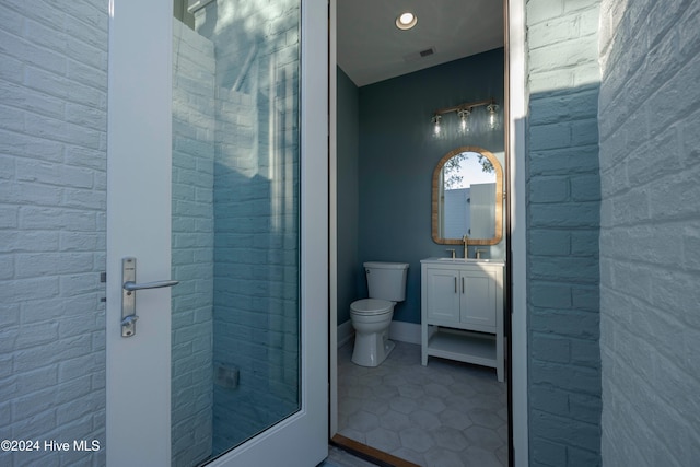 bathroom with vanity, tile patterned flooring, and toilet