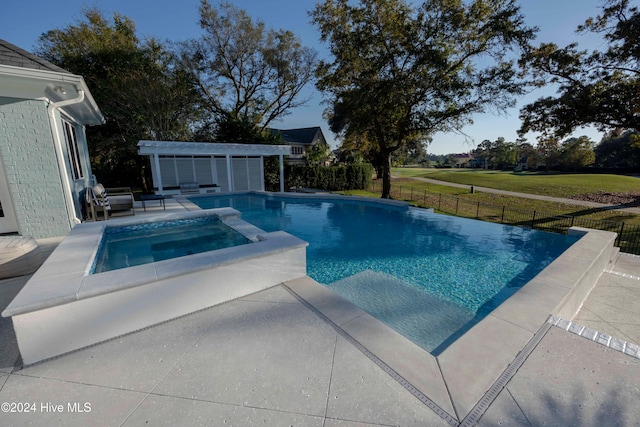 view of swimming pool featuring an in ground hot tub, an outdoor structure, and a patio area