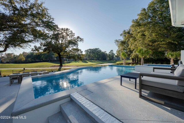 view of swimming pool featuring a patio