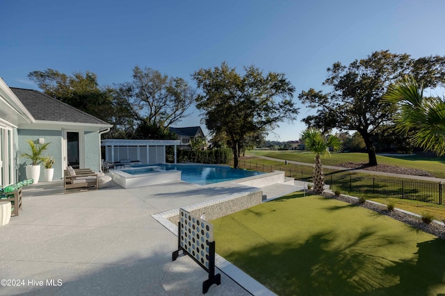 view of pool featuring a patio area and an in ground hot tub