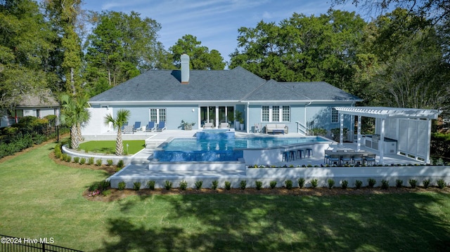 back of property with a yard, a pergola, and a fenced in pool