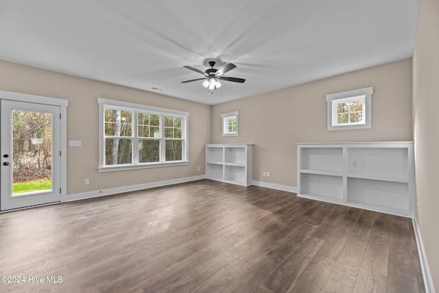 unfurnished living room with wood-type flooring, a wealth of natural light, and ceiling fan