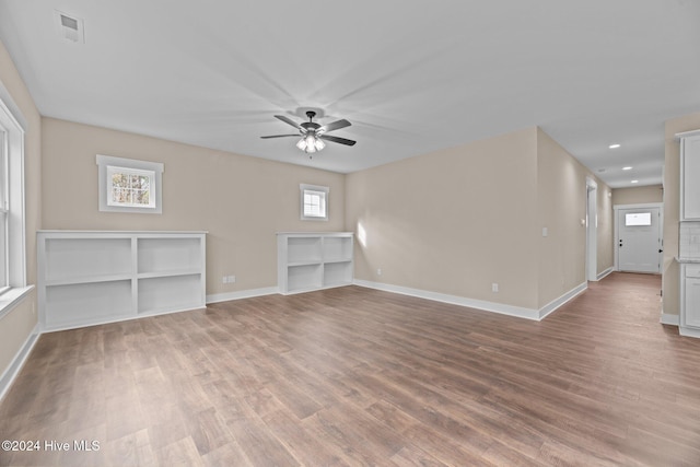 unfurnished living room featuring ceiling fan and light hardwood / wood-style floors