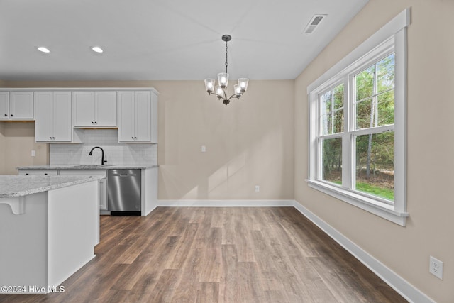 kitchen with stainless steel dishwasher, decorative light fixtures, a notable chandelier, white cabinets, and dark hardwood / wood-style floors