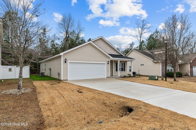 view of front of home with central AC and a garage