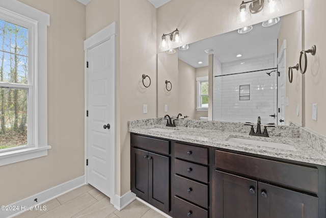 bathroom featuring tile patterned floors, a healthy amount of sunlight, and tiled shower