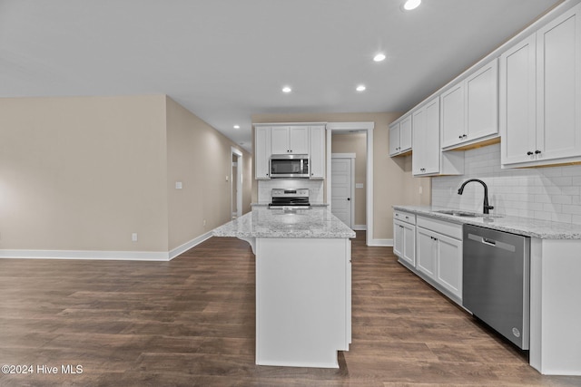 kitchen featuring dark hardwood / wood-style flooring, sink, white cabinetry, and stainless steel appliances