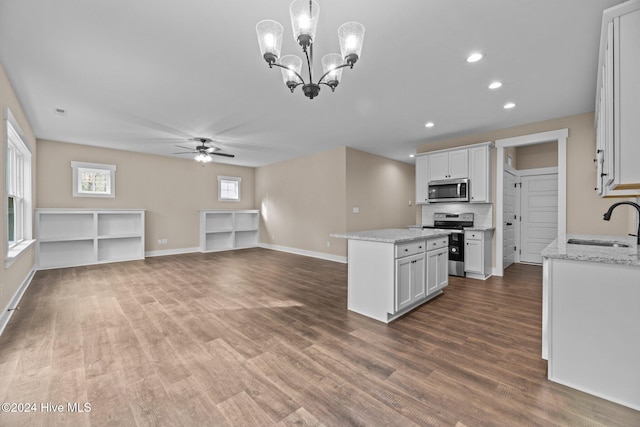 kitchen featuring decorative light fixtures, sink, white cabinetry, and stainless steel appliances