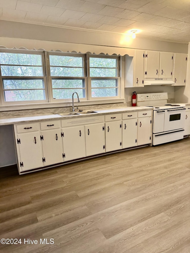 kitchen featuring range with two ovens, white cabinetry, sink, and light wood-type flooring