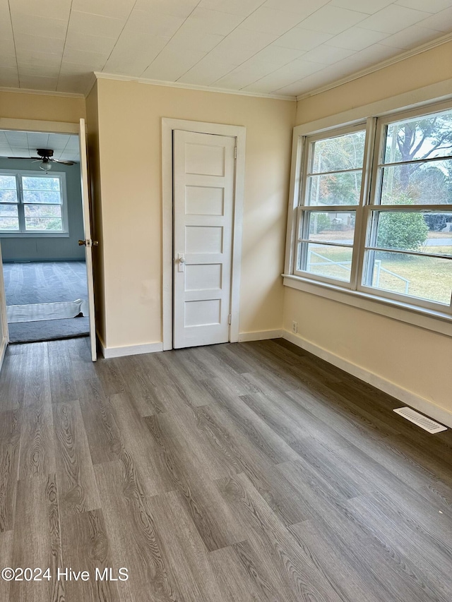 interior space featuring crown molding and hardwood / wood-style floors