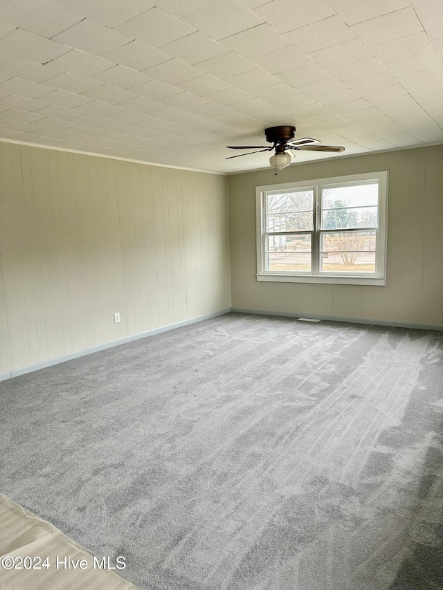 empty room with light colored carpet and ceiling fan