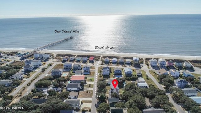 drone / aerial view featuring a beach view and a water view