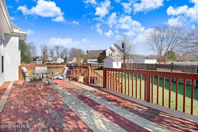 deck with a yard and a storage unit