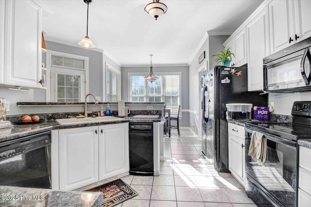 kitchen featuring black appliances, decorative light fixtures, and white cabinets