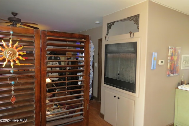 wine room with hardwood / wood-style floors and ceiling fan