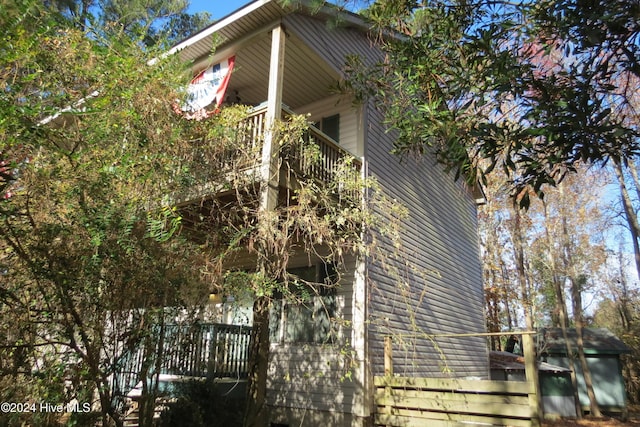 view of side of home featuring a balcony