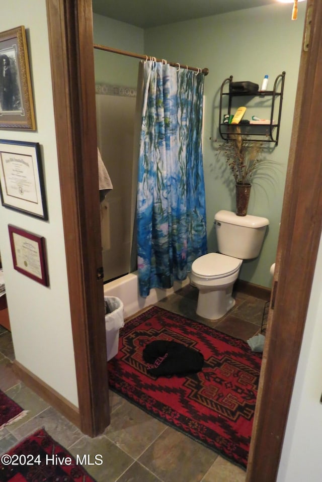 bathroom with toilet and shower / bathtub combination with curtain