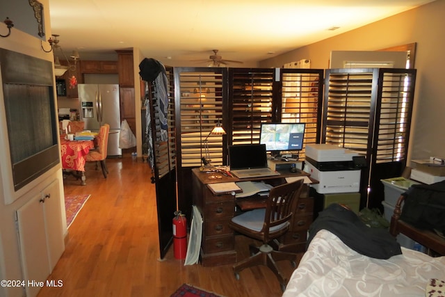 home office with ceiling fan and light hardwood / wood-style flooring