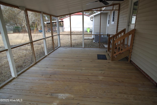 unfurnished sunroom featuring ceiling fan