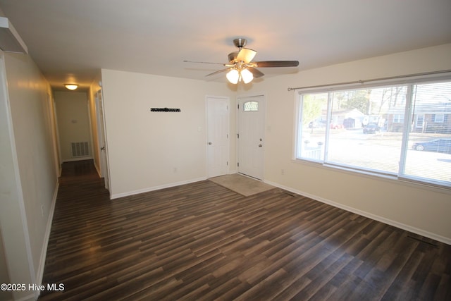 spare room with ceiling fan and dark wood-type flooring