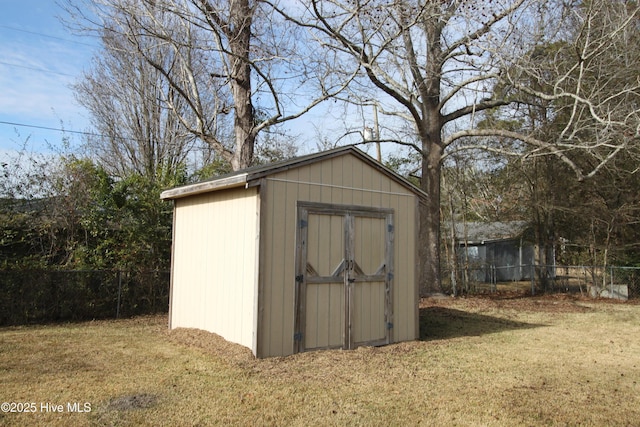 view of outbuilding featuring a yard