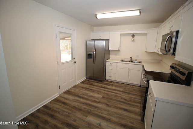 kitchen featuring stainless steel appliances, dark hardwood / wood-style flooring, sink, and white cabinets