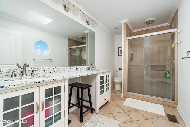 bathroom featuring tile patterned flooring, a shower with shower door, toilet, and ornamental molding