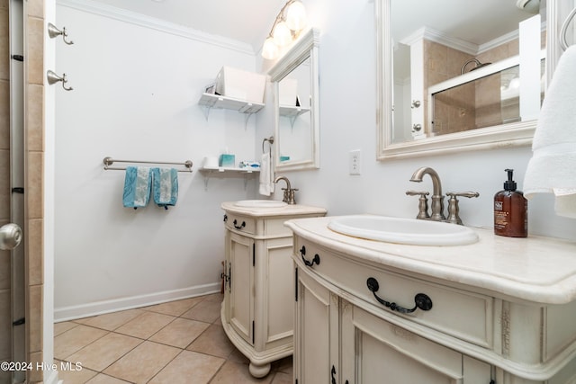 bathroom featuring tile patterned floors, vanity, a shower with shower door, and ornamental molding