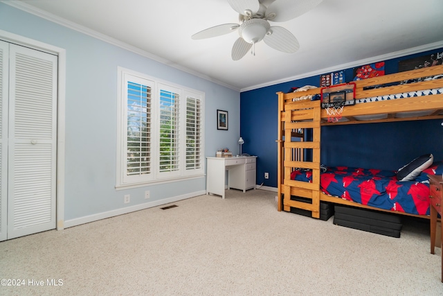 bedroom featuring carpet flooring, ceiling fan, a closet, and ornamental molding