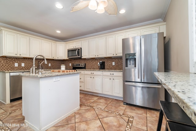 kitchen featuring ornamental molding, light stone countertops, stainless steel appliances, and tasteful backsplash