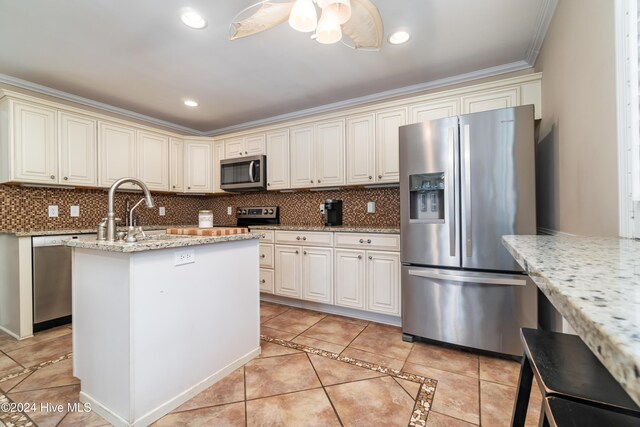 kitchen featuring light stone countertops, sink, appliances with stainless steel finishes, and tasteful backsplash