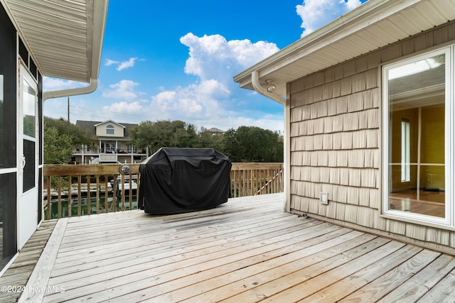 deck with a water view and grilling area