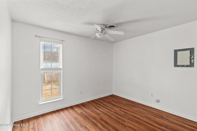 empty room featuring ceiling fan, a textured ceiling, and hardwood / wood-style flooring