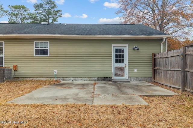 back of property with cooling unit and a patio