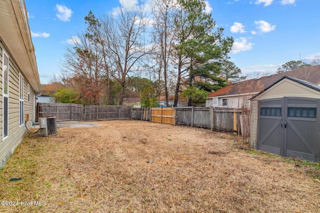 view of yard with central AC and a storage unit