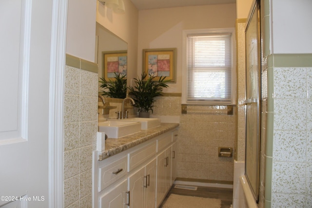 bathroom with vanity and tile walls